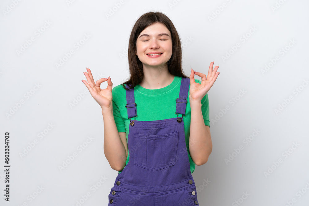 Young Russian woman isolated on blue background in zen pose Young Russian woman isolated on blue background in zen pose
