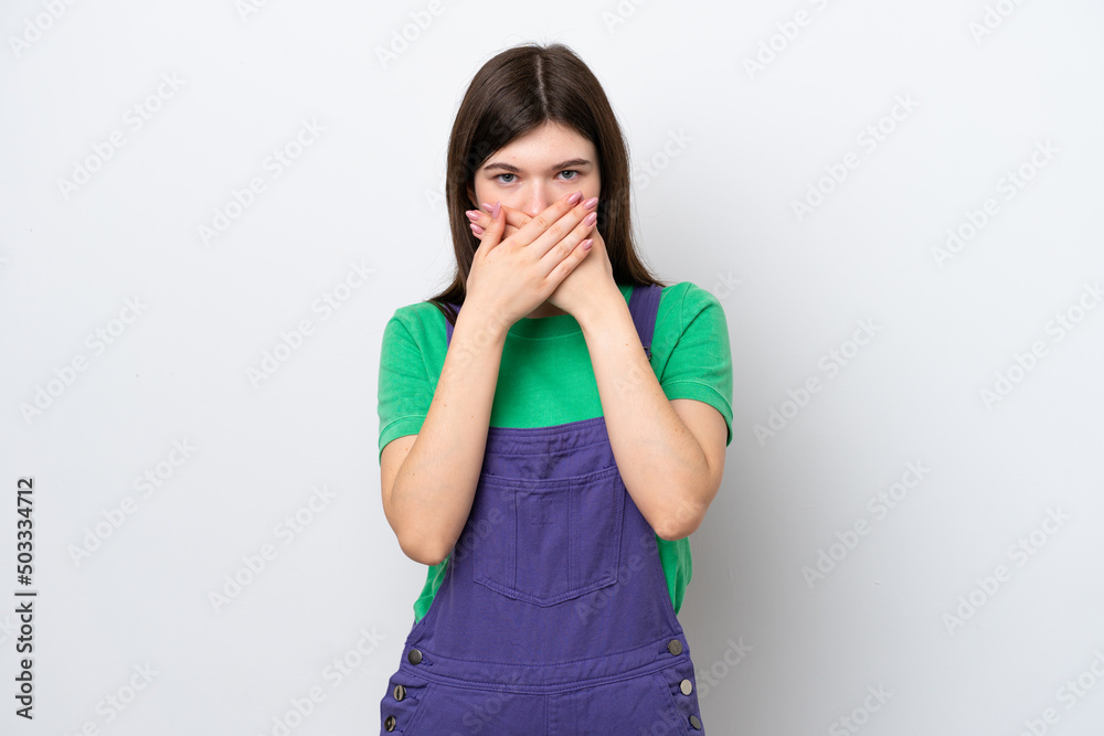 Young Russian woman isolated on blue background covering mouth with hands Young Russian woman isolated on blue background covering mouth with hands