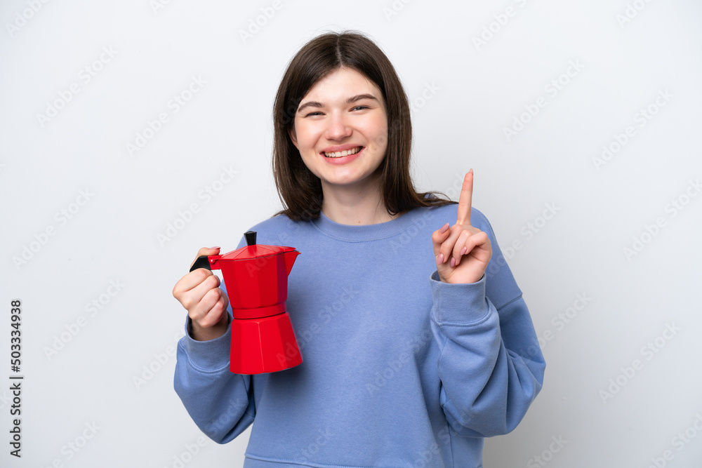 Young Russian woman holding coffee pot isolated on white background showing and lifting a finger in sign of the best Young Russian woman holding coffee pot isolated on white background showing and lifting a finger in sign of the best