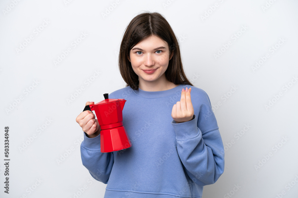 Young Russian woman holding coffee pot isolated on white background making money gesture Young Russian woman holding coffee pot isolated on white background making money gesture