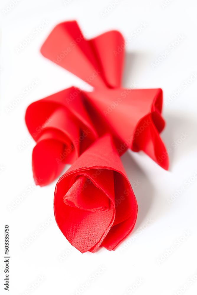 Paper napkins. Close-up of red paper napkins on a whit. Selective soft focus. Paper napkins. Close-up of red paper napkins on a whit. Selective soft focus.