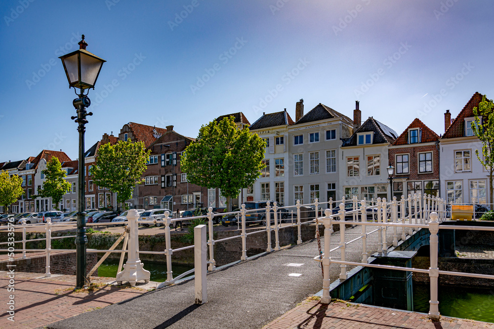 Beautiful old bridge with an ornamental street lamp above a canal in Middelburg 