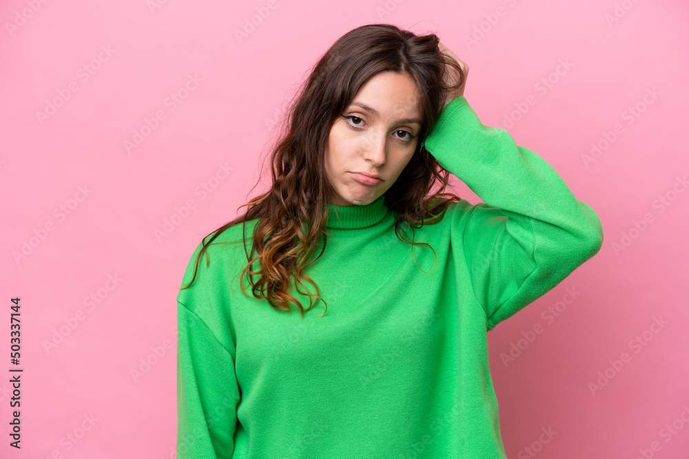 Young caucasian woman isolated on pink background with an expression of frustration and not understanding Young caucasian woman isolated on pink background with an expression of frustration and not understanding