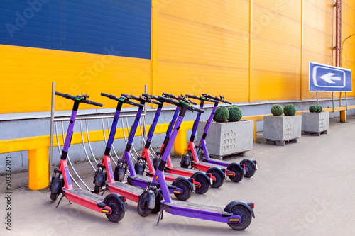 Electric Scooters Public Share Standing Outside European City Center Shop. Public Mobile Transportation