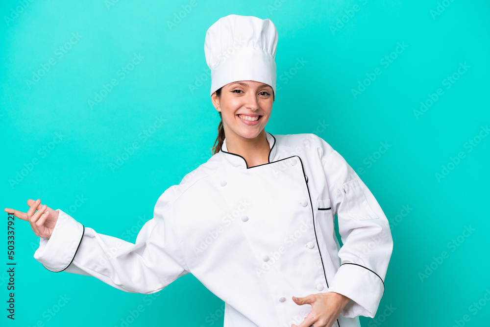Young caucasian chef woman isolated on blue background making guitar gesture Young caucasian chef woman isolated on blue background making guitar gesture