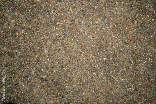 Old weathered and worn concrete exposing the colorful aggregate