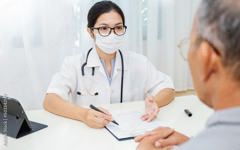 Portrait of asian woman doctor wear protection face mask showing a patient some information on digital tablet clip board, patient listen to specialist doctor in clinic office, medical protect banner Portrait of asian woman doctor wear protection face mask showing a patient some information on digital tablet clip board, patient listen to specialist doctor in clinic office, medical protect banner
