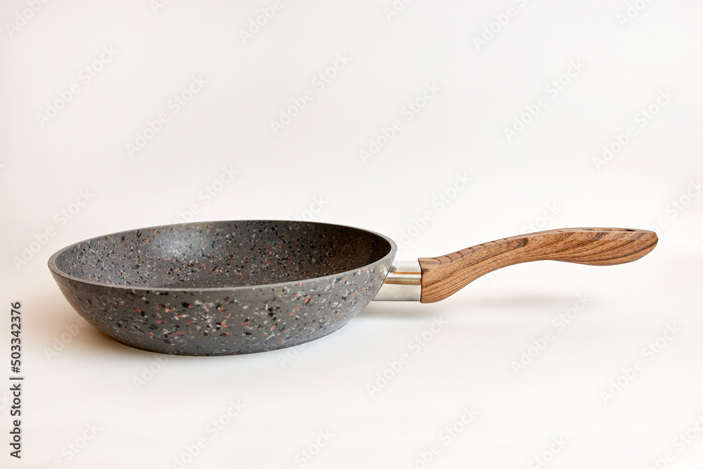 Quality frying pan made of cast iron alloy on a white background. Quality frying pan made of cast iron alloy on a white background.