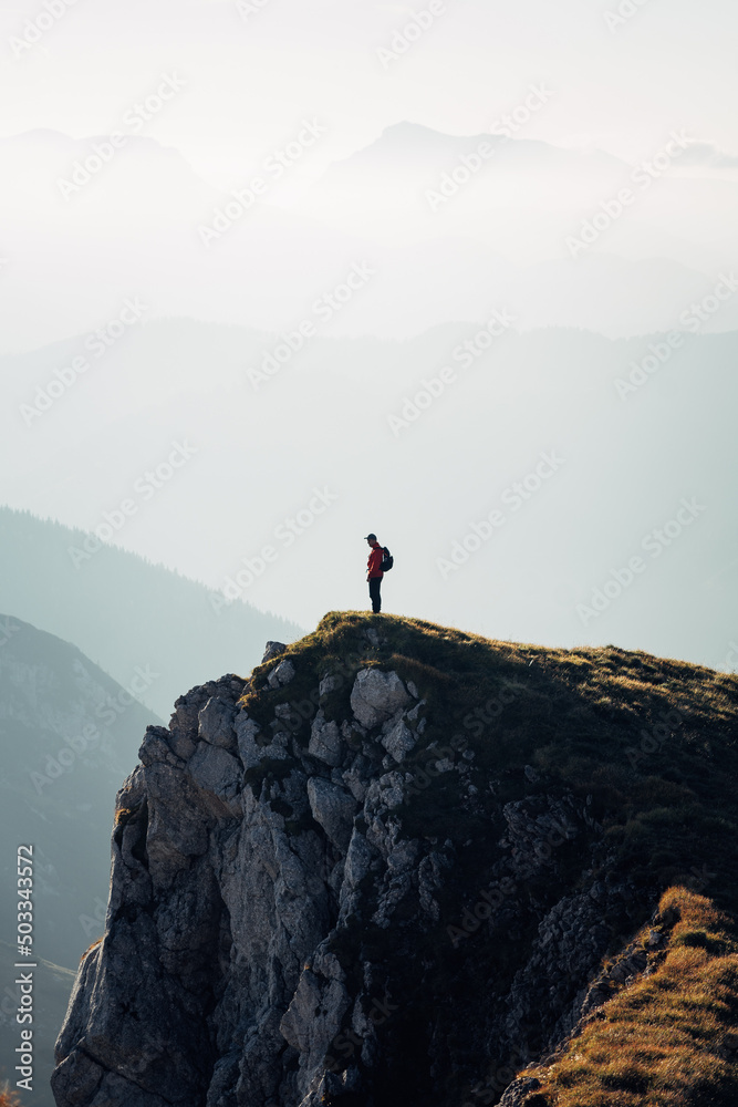 Person standing on top of a mountain Person standing on top of a mountain
