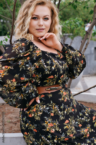 adult beautiful girl model plus size xl in feminine dress floral print retro outdoor portrait