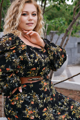 model plus size blonde in trendy retro dress curly blonde in park city walk portrait banner advertising clothes