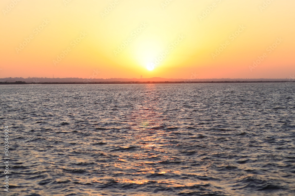 Beautiful Sunset Over The Tropical Sea or Sunset over the arabian Sea. Bright Orange Sun Setting on Beautiful Blue Water. located in Diu district of Union Territory Daman and Diu India