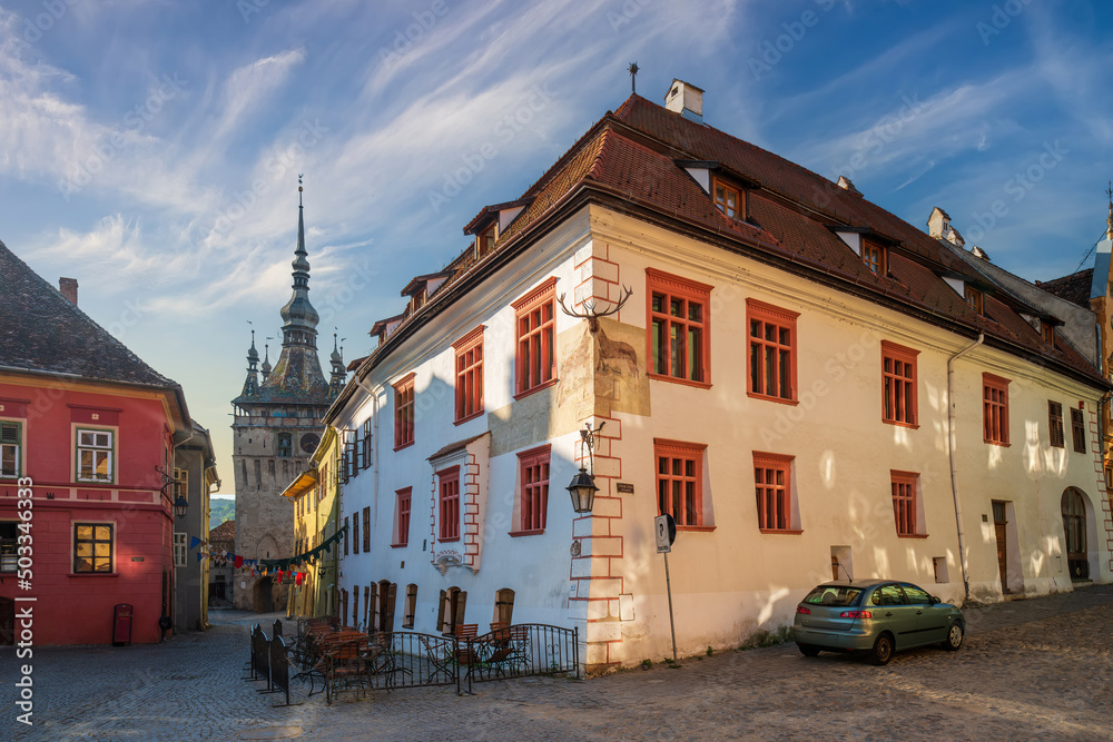 Scenic view of historical Stag house and Clock Tower in the center of old town of Sighisoara, Transylvania, Romania