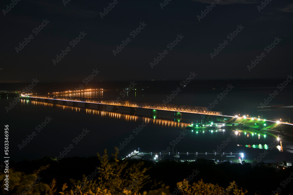 Fototapeta premium Imperial bridge on the Volga river, a picture at night on a long shutter speed. Ulyanovsk, Russia
