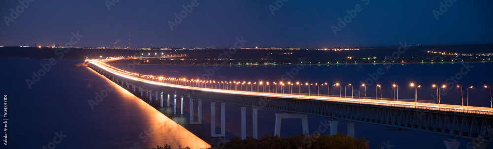 Panorama of The Bridge in night time with illumination. The Presidential Bridge in Ulyanovsk, Russia