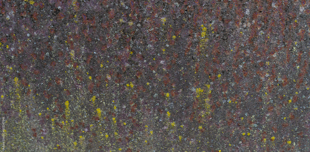 Painted iron surface with a large rusty, black spot and metal corrosion. Old background with peeling and cracking paint. Painted iron surface with a large rusty, black spot and metal corrosion. Old background with peeling and cracking paint.