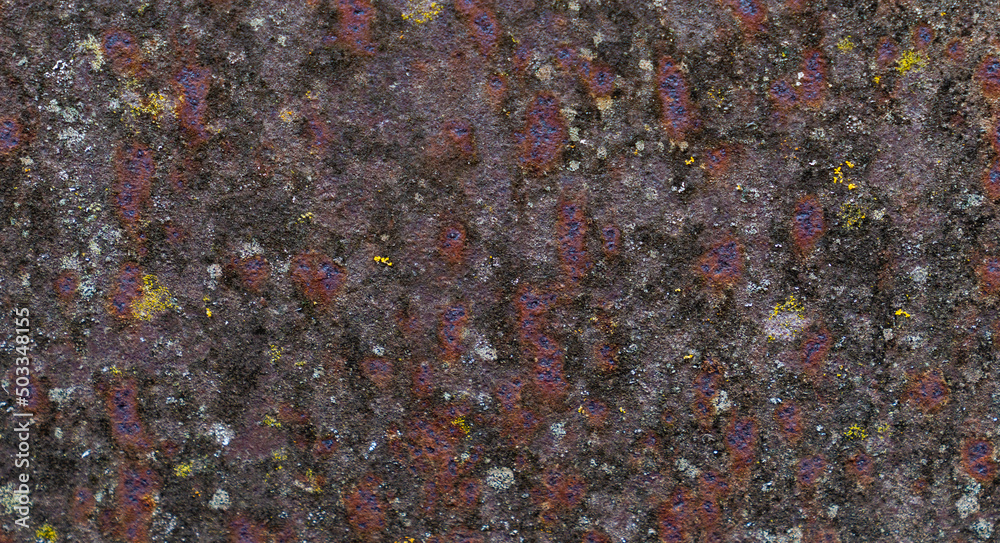 Painted iron surface with a large rusty, black spot and metal corrosion. Old background with peeling and cracking paint. Painted iron surface with a large rusty, black spot and metal corrosion. Old background with peeling and cracking paint.