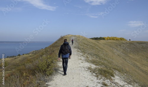 Ulyanovsk Russia, 25 September 2016: A man and a child walk along the ridge of a hill.