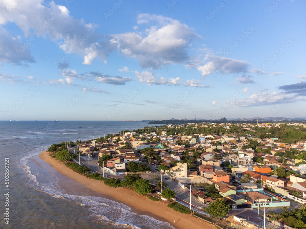 beautiful seaside city of Brazil with dark sand and sunrise on the atlantic ocean - Bicanga, Espirito Santo - aerial drone view