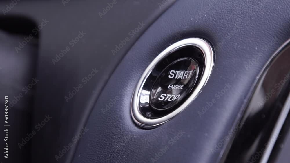 Starting car engine. Track in to the button. Finger press the button to start the car engine Starting car engine. Track in to the button. Finger press the button to start the car engine