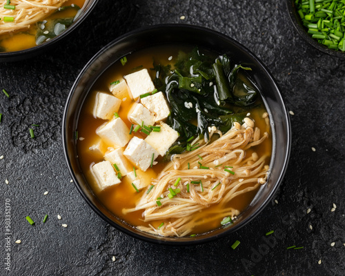 Fotografie Rich miso soup with enoki mushrooms, wakame seaweed and tofu, vegetarian, vegan Asian food