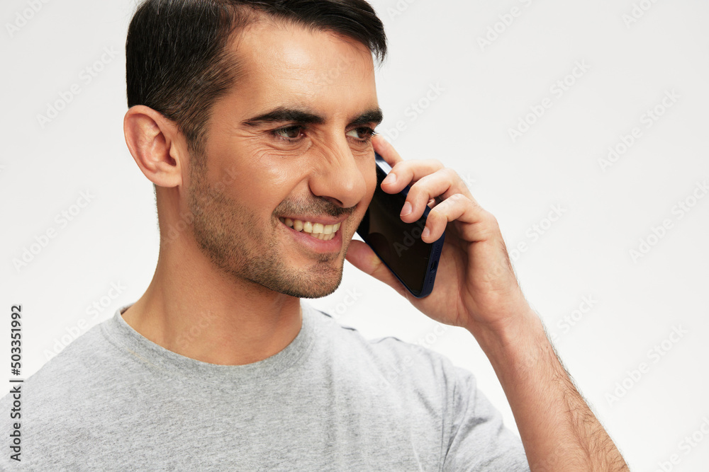 Cheerful man phone conversation lifestyle smile light background Cheerful man phone conversation lifestyle smile light background