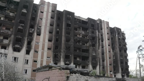Damaged residential building in the Bucha city, Kyiv region during the fighting after the Russian attack on Ukraine. Russian-Ukrainian war. Aerial. Fire in the house. 