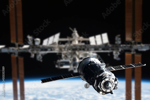 Fototapeta Naklejka Na Ścianę i Meble -  International Space Station in orbit. Docking of the Russian Soyuz spacecraft. Elements of this image furnished by NASA.