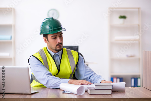 Young male architect working in the office