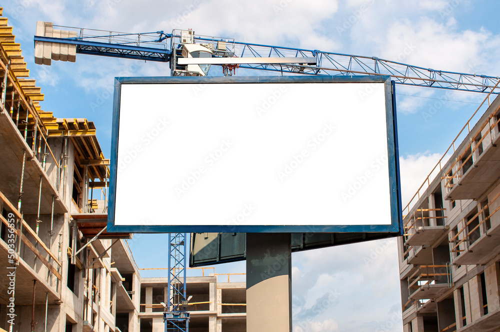 Blank white advertising billboard on the construction site