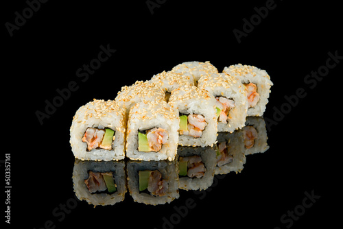 roll with shrimp and avocado with sesame on black with reflection
