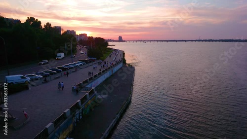 The magical twiligts with its purple sky above overcrowded embankment in Dnipro city, Ukraine photo