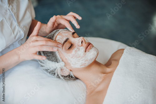 Caucasian woman getting lifting therapy massage in a spa salon.Skin care. Rejuvenation treatment.