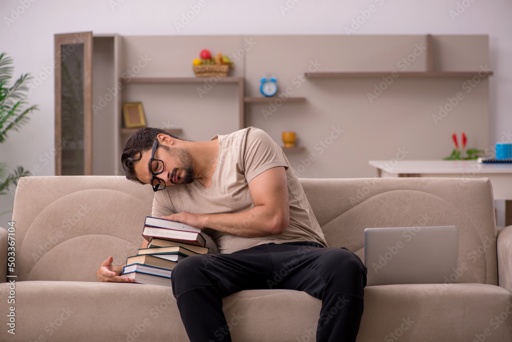 Young male student studying at home during pandemic Young male student studying at home during pandemic