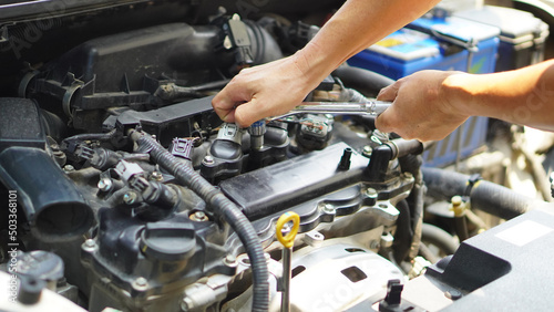 Check the engine system, professional technicians, working, checking the condition of the car, repairing the damaged engine. 