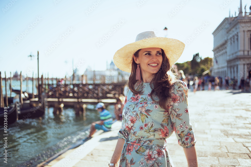 happy modern woman in floral dress having walking tour