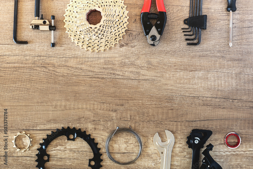 Bicycle parts and specialized service keys on a brown wooden background ...