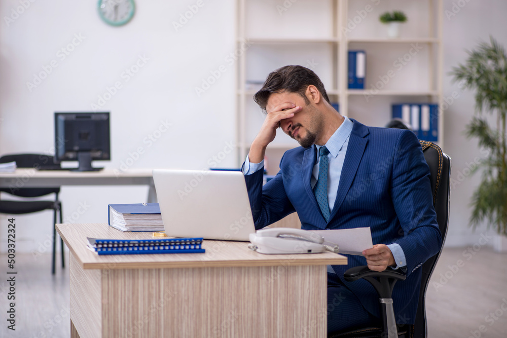 Young male employee working in the office