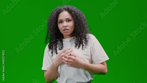 frightened woman with curly long hair dressed white tee Isolated on Green Screen