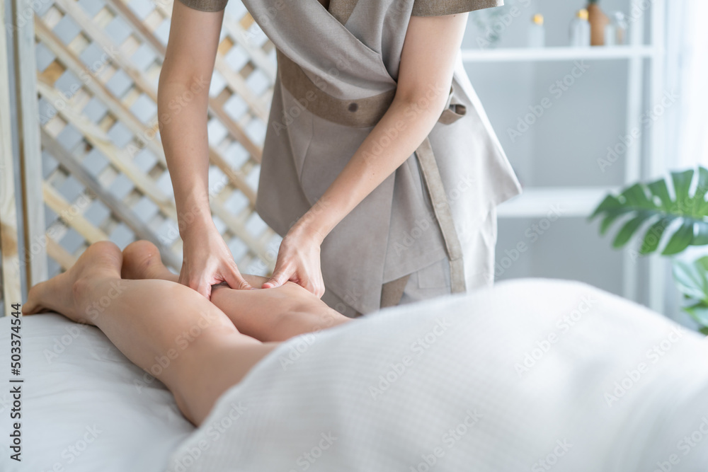 Close up of young client girl feel relaxed during leg massage with oil. Close up of young client girl feel relaxed during leg massage with oil.