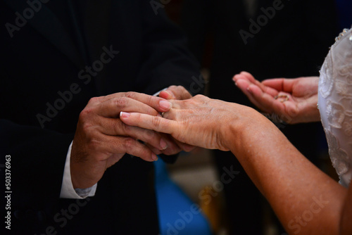 hands of the bride and groom in the exchange of rings 