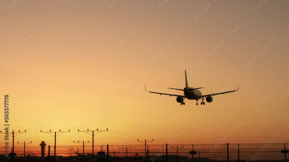 Airplane approaching and landing at early morning in Los Angeles, California, United States of America. Plane flying over head, landing at airport at sunset or sunrise, RED camera footage background Airplane approaching and landing at early morning in Los Angeles, California, United States of America. Plane flying over head, landing at airport at sunset or sunrise, RED camera footage background