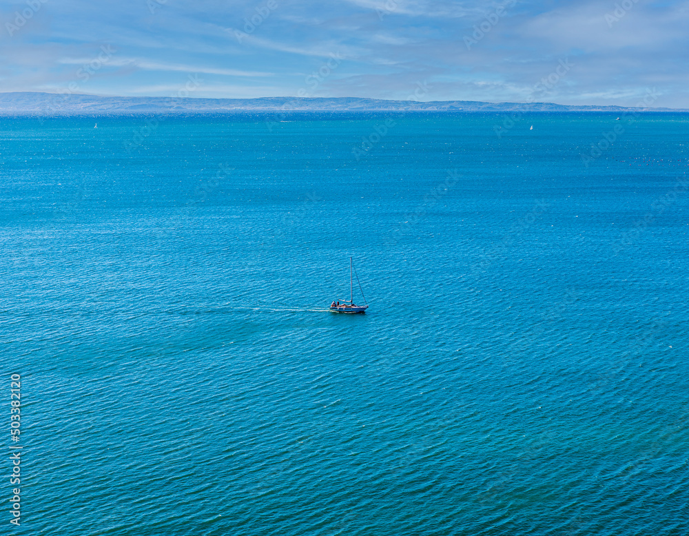 The yacht is on the emerald Adriatic Sea near Duino, Gulf of Trieste, Italy.Breeze The yacht is on the emerald Adriatic Sea near Duino, Gulf of Trieste, Italy.Breeze