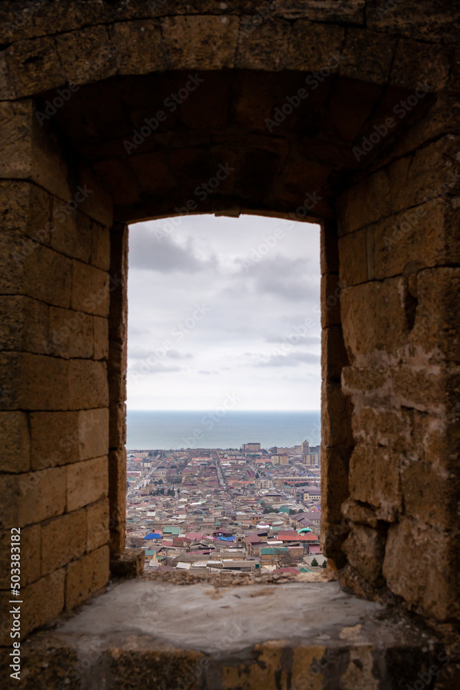 Fototapeta premium Derbent fortress Naryn Kala is the main touristic attraction in the city. Dagestan, North Caucasus, Russia. the city of Derbent in the distance, the blue sea and the sky.