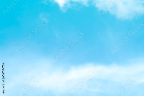 Soft clouds on bright blue sky background and copy space