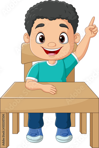 Cartoon little boy sitting on table with pointing up