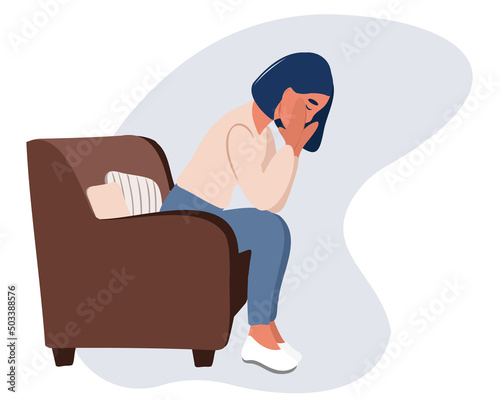 Young tired woman sitting on the sofa with her eyes closed, holding her head with her hand, suffering from severe sudden headache or migraine, throbbing pain. Stress worker. Business woman in a panic.