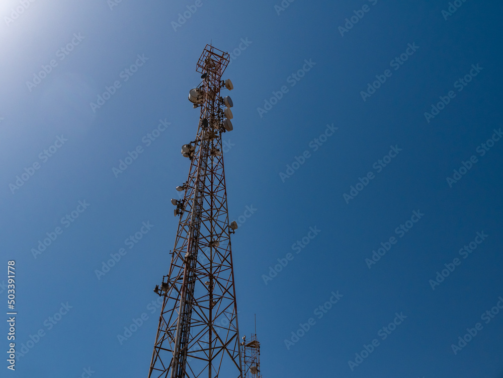 Relay tower with many antennas against the blue sky. Relay tower with many antennas against the blue sky.