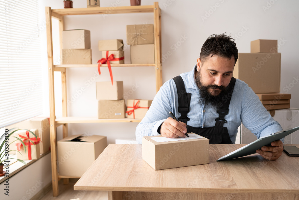 Start up entrepreneur of indian millennial man with box for packaging order from shopping online working at home office, small business owner making order delivery, small business shipping Start up entrepreneur of indian millennial man with box for packaging order from shopping online working at home office, small business owner making order delivery, small business shipping