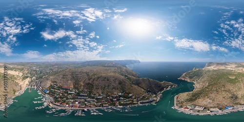 Aerial panoramic view of Balaklava landscape with boats and sea in marina bay. Seamless 360 degree spherical equirectangular panorama. Drone top view shot of port for luxury yachts and sailboats.